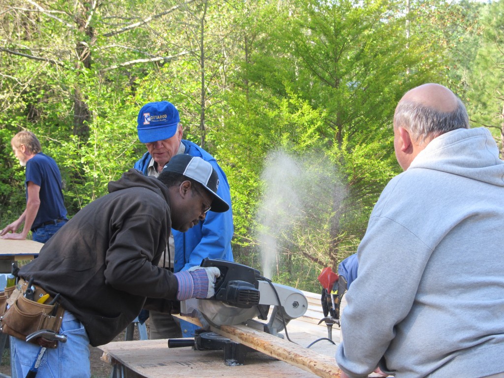 Sherwood Forest Camp Trades Weekend - cutting wood outside