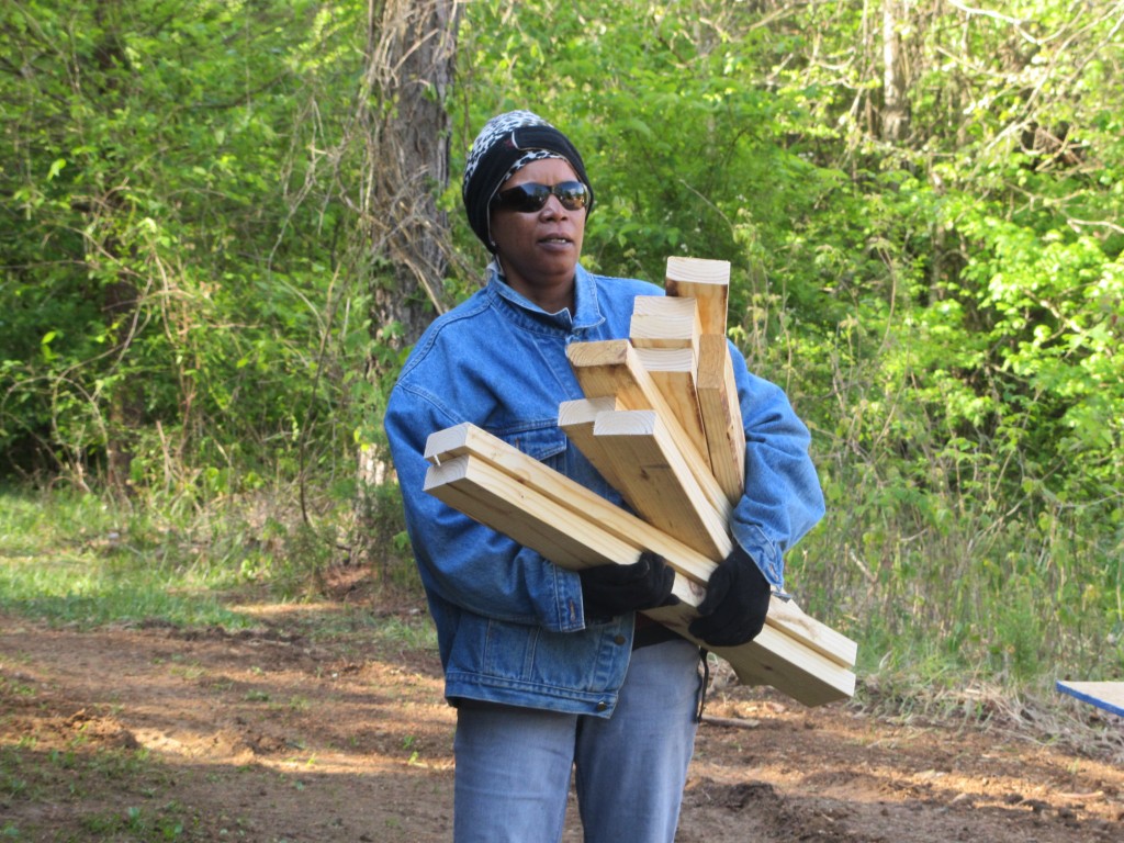 Sherwood Forest Camp Trades Weekend - volunteer carrying wood