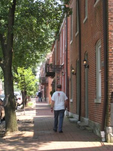 Man walking in urban area on sidewalk
