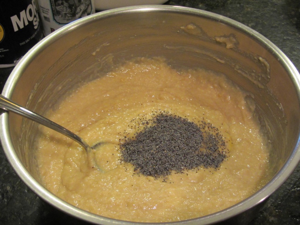 Poppy seed almond muffins adding poppyseeds