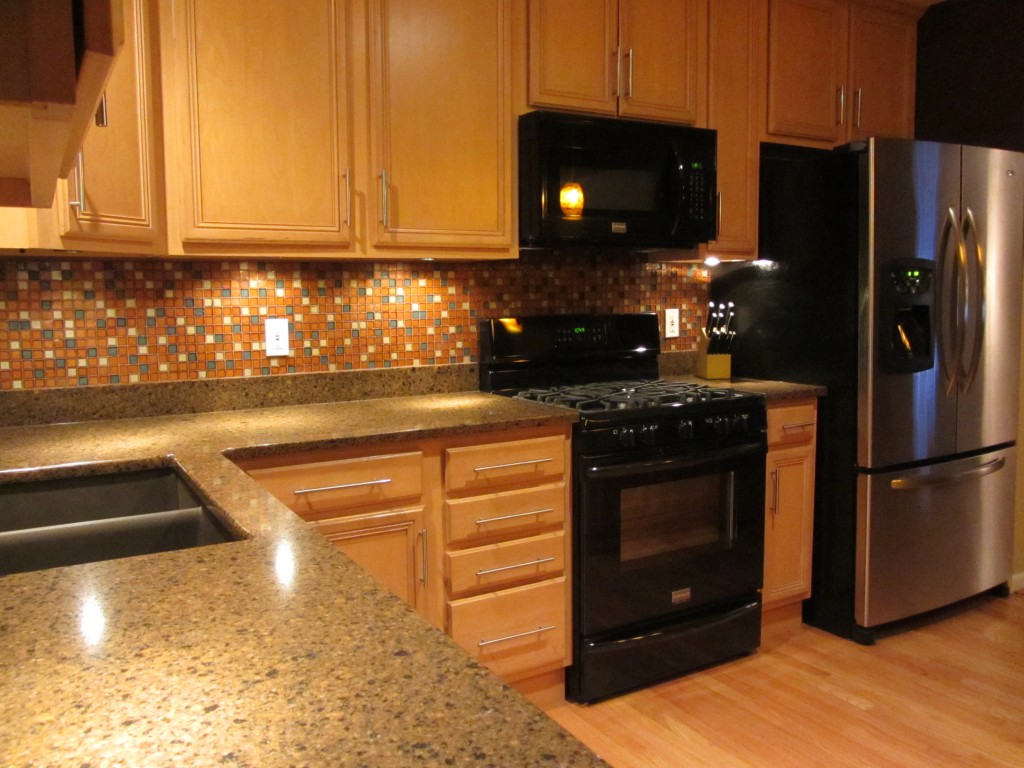 Under cabinet lighting with granite and glass tile backsplash