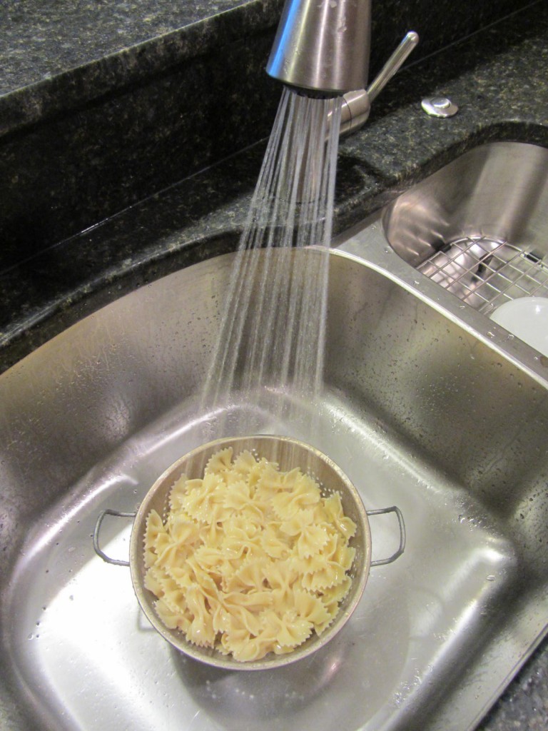 Pasta being sprayed in sink